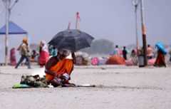 People brave heat wave conditions during a hot summer day in Uttar Pradesh, India.