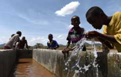 Children drink water from a pipeline in the village of Afraaga, Somaliland.
