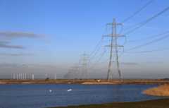 Pylons and wind farm in Dungeness, Kent, UK.