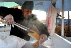 CTC-L-ICE-trauma09.JPG Street vendor Carlos Garcia uses tongs to bag steaming tamales at the family’s tamale cart along 26th Street in Chicago’s Little Village on Nov. 22, 2025. (Antonio Perez/Chicago Tribune)