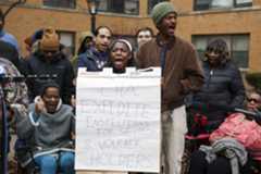 ctc-l-south-shore-union-10.JPG Southside Together member Alajah Wills, center, holds a sign while participating in a chant with tenants and community members in front of the recently raided South Shore apartment building on Nov. 24, 2025. The news conference announced the formation of the 7500 South Shore Tenants Union. (Eileen T. Meslar/Chicago Tribune)