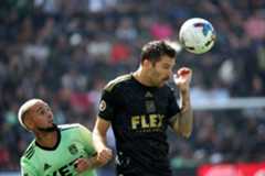 Los Angeles FC midfielder Ryan Hollingshead, right, heads the ball...