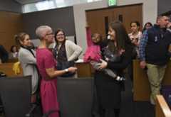 Kerry Meyer holds Sierra Jean Haggerty Meyer, 2, as they come into the courtroom during 14th annual Denver Adoption Day at the Lindsey-Flanigan Courthouse, on Nov. 9, 2018, in Denver. Kerry Meyer, a single mother from Denver, is adopting Sierra. (Photo by RJ Sangosti/The Denver Post)