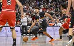Cameron Johnson (23) of the Denver Nuggets drives as Isaac Okoro (35) of the Chicago Bulls defends during the third quarter at Ball Arena in Denver on Monday, Nov. 17, 2025. (Photo by AAron Ontiveroz/The Denver Post)