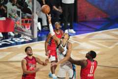 All-Star_Weekend_Basketball_02453 World center Victor Wembanyama, of France, shoots over USA Stars guard Devin Booker, left, and forward Jalen Duren during the NBA All-Star basketball game Sunday, Feb. 15, 2026, in Inglewood, Calif. (AP Photo/Jae C. Hong)