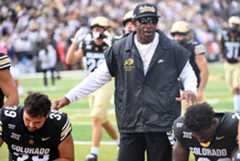 DCC-L-CUGT30_da7331 University of Colorado Buffaloes head coach Deion Sanders checks in with his players before a game against Georgia Tech at Folsom Field in Boulder, Colo., on Friday, Aug. 29, 2025. (Photo by Cliff Grassmick/Staff Photographer)