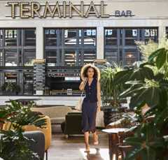 a woman talking through the great hall at Denver Union Station