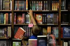 kid grabbing books from a shelve inside denver union station
