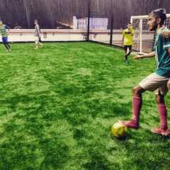 A Complete Guide to Futsal History 3 Players playing football on a rainy day on football turf in Chennai.