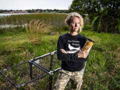 Corina with her grackle trap and trapping food in Florida