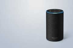 An Amazon Echo smart speaker with a blue light ring at the top, set against a professional light gray background with subtle geometric patterns.