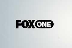 The Fox One logo, featuring FOX in bold black letters and ONE in white letters within a black rounded rectangle, centered on a professional light gray background with subtle geometric patterns.