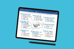 A tablet displaying a business plan mind map, with a stylus resting below it, set against a professional flat blue background.