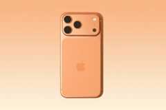 A peach-colored smartphone with three camera lenses and an Apple logo on the back, presented on a peach background with a subtle hexagonal pattern.