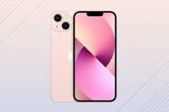 A pink iPhone 13, with its front and back visible, set against a professional flat design background with soft pink and white gradients and subtle diagonal line patterns.
