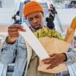 Man looking at his grocery receipt, symbolising inflation.