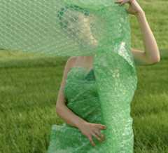 recycling in Israel, a woman wearing a green packing roll