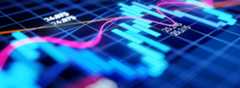 A close-up of a digital financial chart displays blue bar graphs, pink and orange trend lines, and white numerical data values on a dark grid background, representing stock market or trading data analysis.