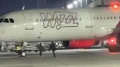 Români filmați alergând după un avion Wizz Air, pe pista aeroportului din ...
