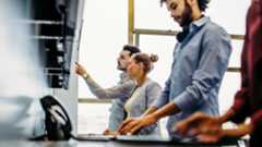 two males behind computer screen