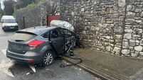 Two hospitalised after car hits wall and catches fire in Blackrock