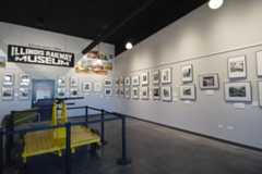 The interior of the Post Office Exhibit Hall at the Illinois Railway Museum showing a photography exhibit and a railroad handcar