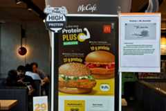 An advertisement for McDonald's new protein slice is displayed on an ordering kiosk at a McDonald's restaurant in Bengaluru, India