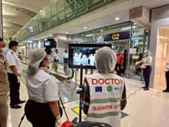 Airport health authorities wearing protective masks monitor passengers from international flights arriving at Suvarnabhumi International Airport in Bangkok on Sunday.