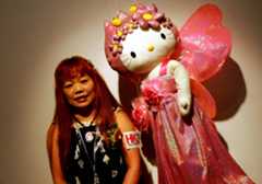 Hello Kitty designer Yuko Yamaguchi poses with a "Fairy Hello Kitty" at an exhibition during the celebration of the 30th anniversary of the Japanese cartoon character in Hong Kong in 2005.