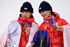 Gold medalist Yuto Totsuka of Japan (left) and bronze medalist and compatriot Ryusei Yamada pose on the podium after the snowboard men's halfpipe final during the Milano Cortina 2026 Winter Olympic Games in Livigno, Italy, on Friday.