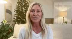 Greene speaks into a camera in her living room.