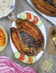 daing na bangus on a white serving platter.