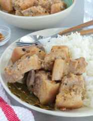 White pork adobo on a plate with steamed rice.