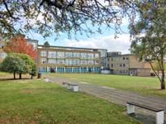 Photo of The Halley Academy building taken from a green space on the academy grounds.