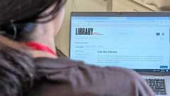 A person looking at a Library of Congress webpage on laptop computer.