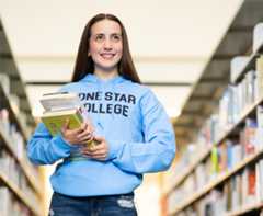 4 students in cap and gown with fireworks in the background.