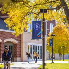 Students in front of the Leonard Center on an autumn day.