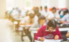 Blur,Abstract,Background,Of,Examination,Room,With,Undergraduate,Students,Inside.