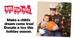 Toys for Tots advertisement. The photo shows a member of the United States Marine Corps with a young child, posing in front of a Christmas tree. The Marine is wearing the Blue Dress uniform. Both the Marine and the child are holding a basketball together. Next to this image is the Toys for Tots train logo, with text underneath that says, "Make a child's dream come true! Donate a toy this holiday season."