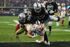 APTOPIX 49ers Raiders Football San Francisco 49ers running back Christian McCaffrey (23) breaks through tackles by Las Vegas Raiders cornerback Nate Hobbs (39) and Tre'von Moehrig (25) to score a 14-yard touchdown during the second half of an NFL football game between the San Francisco 49ers and Las Vegas Raiders, Sunday, Jan. 1, 2023, in Las Vegas. (AP Photo/John Locher)