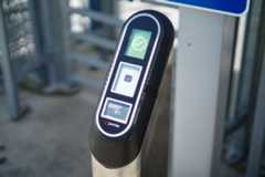 A fare validator outside of a security gate.