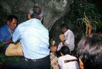Pic 5: People dedicating offerings at the cave of the water spirit.