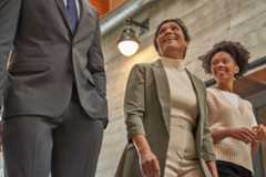 Decision makers (DMs) and team collaborating in a hallway.