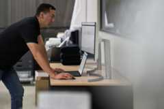 Security practitioner looking at desktop screens and working to investigate threats.