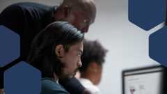 A group of people looking at a computer screen