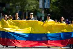 People carry a giant Colombian flag at a parade in Washington, DC.