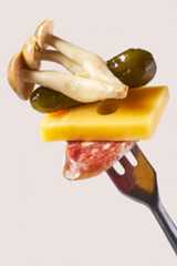 A bite of pickled beech mushrooms on the tip of a fork
