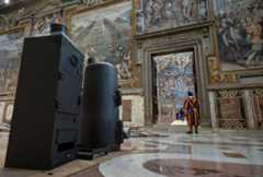 The stove that will be used to burn ballots during the conclave to elect a new pope in the Sistine Chapel and the machine that adds chemicals to create dark black or bright white smoke are seen at the Vatican May 2, 2025. Cardinals under the age of 80 will enter the conclave May 7. (CNS/Vatican Media)