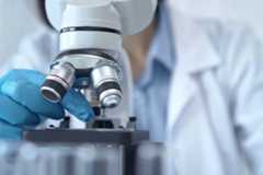 Scientist using microscope in laboratory