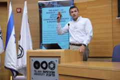 Andres Cardenas speaking at a podium